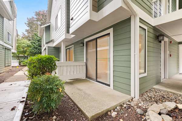 A green house with a white door and windows. at AVIA Lofts on Parkway, Vancouver Washington